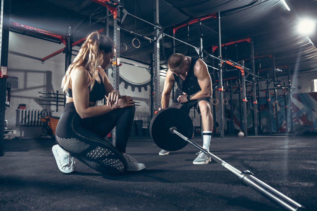 Athletic man and woman with a dumbbells